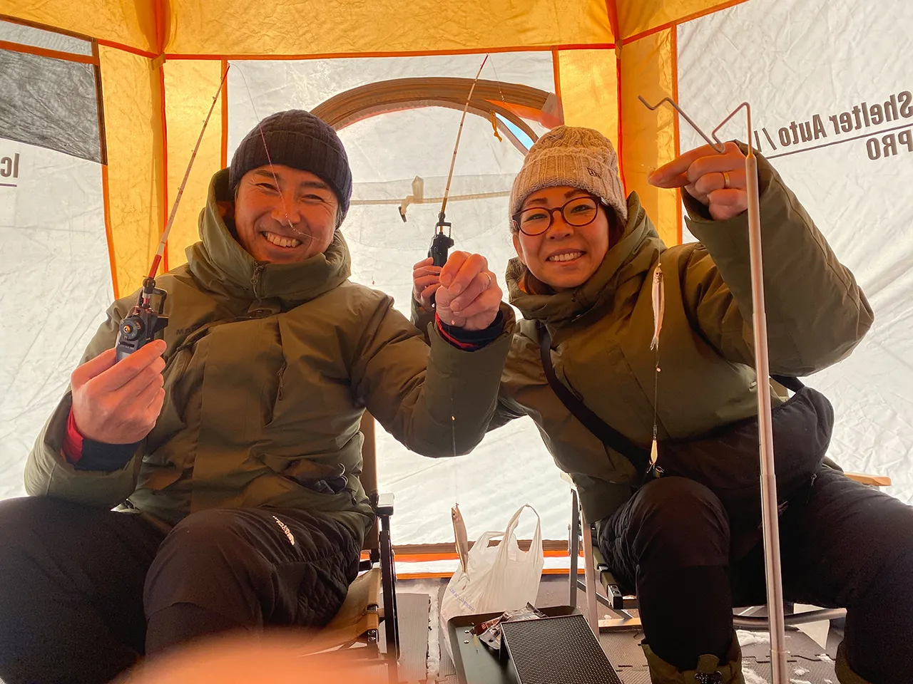 Guests enjoying wakasagi ice fishing on the ice