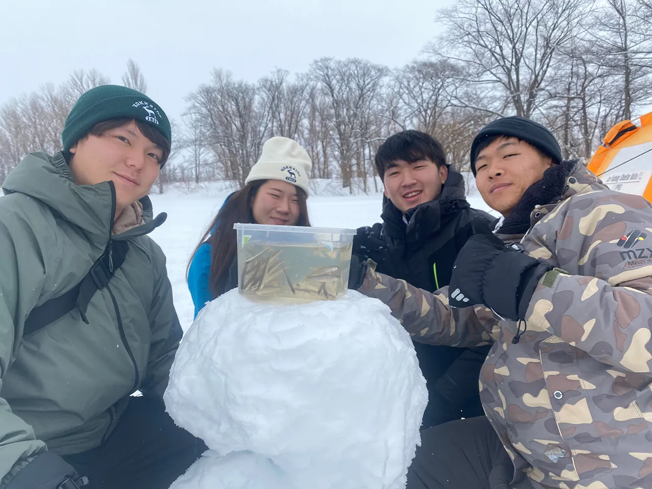 Guests enjoying wakasagi ice fishing on the ice
